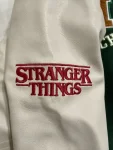 Stranger-Things-X-HM-Hawkins-Tigers-Varsity-Jacket.webp